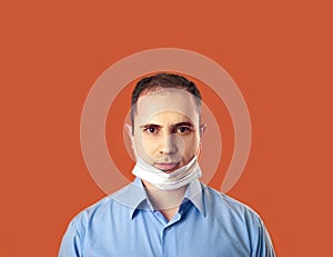 Incorrectly worn medical mask. Frontal view of a man wearing a surgical medical mask incorrectly. Empty space for text. indoor