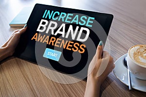 Increase brand awareness text on screen. Advertising and marketing concept.