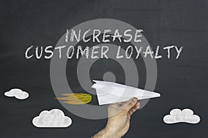 Increase customer loyalty concept on blackboard