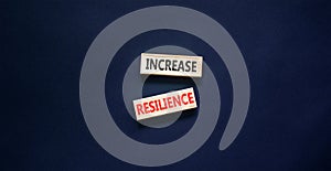 Increase resilience symbol. Concept word Increase resilience typed on wooden blocks. Beautiful black table black background.