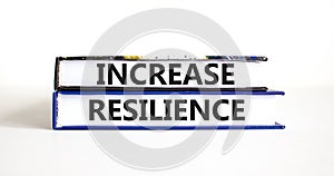 Increase resilience symbol. Concept word Increase resilience typed on books. Beautiful white table white background. Business and