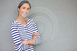 Increased confidence with maturity. Portrait of an attractive mature woman in casualwear standing against a gray wall.