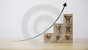 Increasing trend graph of sale volume with bigger shopping trolley cart for online sale business and ecommerce growth concept