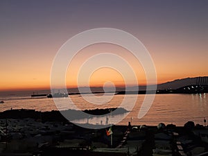 An incredibile caption of the beautiful sunset over the sea of Genova by night with some beautiful lights photo