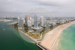 Incredible daytime aerial view of South Pointe high-rise condominiums looking down Miami Beach with sandy shores lining the