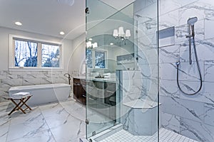 Incredible master bathroom with Carrara marble tile surround.