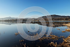 Incredible mirror on water surface on water dam near Frydek-Mistek, czech republic. Sunrise on Olesna dam. Reservoir with blue sky