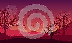 Incredible mountain panorama at night with the silhouettes of dry trees around it. Vector illustration