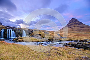 Incredible Nature landscape of Iceland. Fantastic picturesque sunset over Majestic Kirkjufell (Church mountain) and waterfalls.