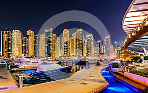 Incredible night dubai marina skyline. Luxury yacht dock. Dubai, United Arab Emirates.