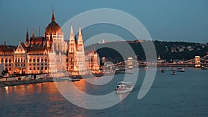 Incredible picturesque sity landscape of the Parliament, the bridge and ships on the Danube in Budapest, Hungary at sunset.