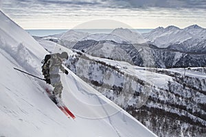 Incredible skiing in the snowy Caucasus mountains, good winter day, freeride in a deep snow, ski season