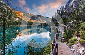 Incredible view on majestic famouse lake Braies during sunrise. Wonderful sunny landscape in dolomites Alps with perfect sky.