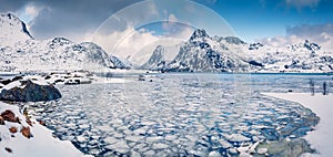 Incredible winter scene over polar circle. Frozen Boosen fjord on Flakstadoya island. photo