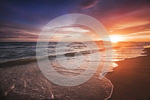 Incredibly beautiful sunset on the beach in Thailand. Sun, sky, sea, waves and sand. A holiday by the sea photo