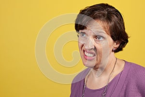 Incredulous Attractive mature woman in purple blouse photo