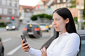 Incredulous woman reading a message on a mobile