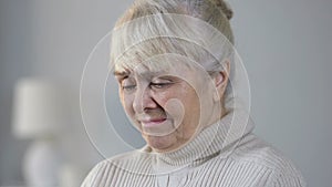 Incurably sick retiree female crying and thinking about life, feeling helpless