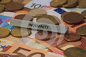 indemnity - the word was printed on a metal bar. the metal bar was placed on several banknotes