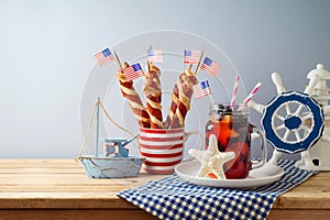 Independence Day, 4th of July  festive table setting  with summer fresh fruit drink, twisted hot dog sausages and nautical
