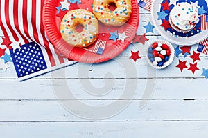 Independence Day background on 4th of July with american flag, stars and food on wooden table top view.