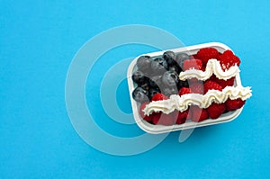 Independence day, happy fourth of july and sweet dessert concept with the american flag made of raspberries, blueberries and