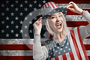 Independence Day. Happy young woman dressed in american flag clothes on american flag background