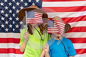 Independence Day. Patriotic holiday. Happy kids, cute two girls with American flag. Cowboy. USA celebrate 4th of July. Girls cover