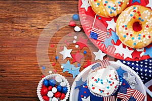 Independence Day 4th july background with american flag decorated of sweet foods, stars and confetti. Holidays table top view.