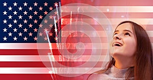 Independence day usa party background,banner of American flag and delighted girl looks at the fireworks,fourth july celebration