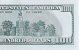 Independence Hall on 100 dollars banknote back side closeup macro fragment. United states hundred dollars money bill