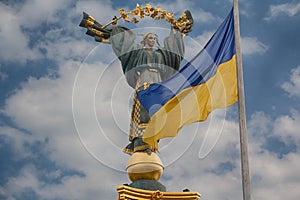 Independence monument and ukrainian flag in Kiev photo