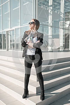 Independent confident young business woman standing outside office building