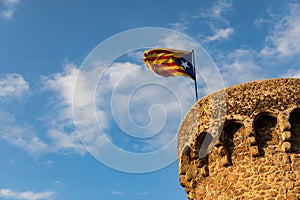 Independentist flag waving on top of medieval tower cloud