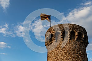 Independentist flag waving on top of medieval tower cloud