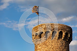 Independentist flag waving on top of medieval tower cloud