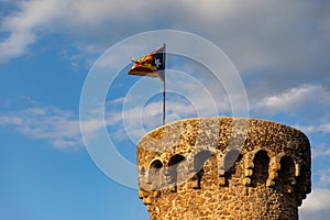 Independentist flag waving on top of medieval tower cloud