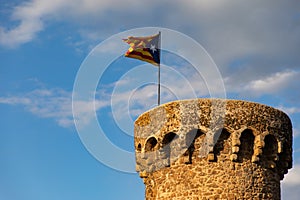 Independentist flag waving on top of medieval tower cloud