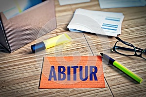 Index cards with legal issues with glasses, pen and bamboo with the german word Abitur in english exam