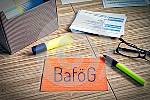 Index cards with legal issues with glasses, pen and bamboo and the german word BafÃÂ¶g to symbolize the german bafÃÂ¶g law for the s