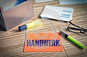 Index cards with legal issues with glasses, pen and bamboo with the german word Handwerk in english craft