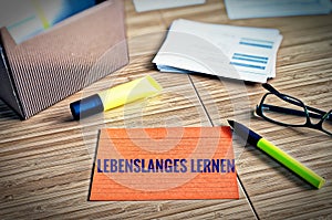 Index cards with legal issues with glasses, pen and bamboo with the german words Lebenslanges Lernen in english lifelong learning