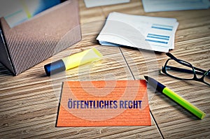 Index cards with legal issues with glasses, pen and bamboo with the german words Ã–ffentliches Recht in english public law