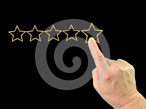 Index finger and five stars. Finger touch on the monitor. A man gives a high score with five stars. Concept: quality mark, level