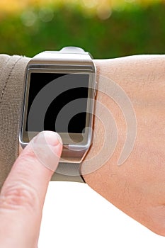 Index finger on a partially isolated smartwatch