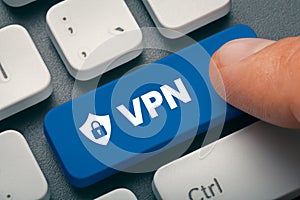 Index finger pressing computer key with vpn word and symbol