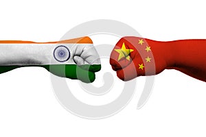 India - China relations concept. Flags of India and China painted on hands fists facing each other on white background