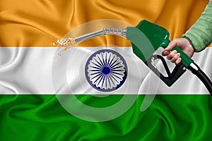 INDIA flag Close-up shot on waving background texture with Fuel pump nozzle in hand. The concept of design solutions. 3d rendering