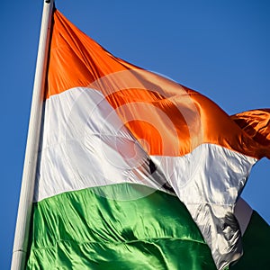 India flag flying high at Connaught Place with pride in blue sky, India flag fluttering, Indian Flag on Independence Day and