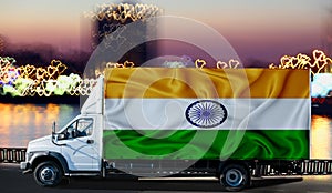 India flag on the side of a white van against the backdrop of a blurred city and river. Logistics concept